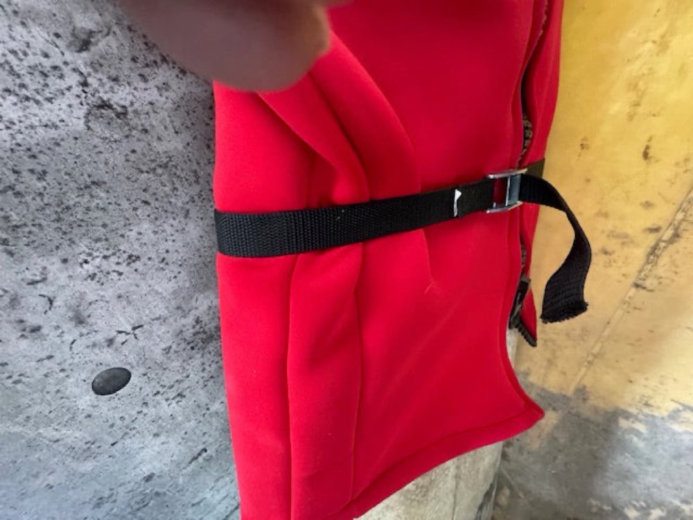 Girdle zipped and snug-strapped around the surfboard.