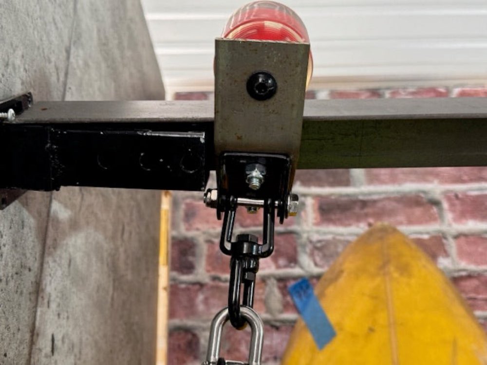 Skate-wheel hardware on the slide track, off a wall/closet mount bracket.