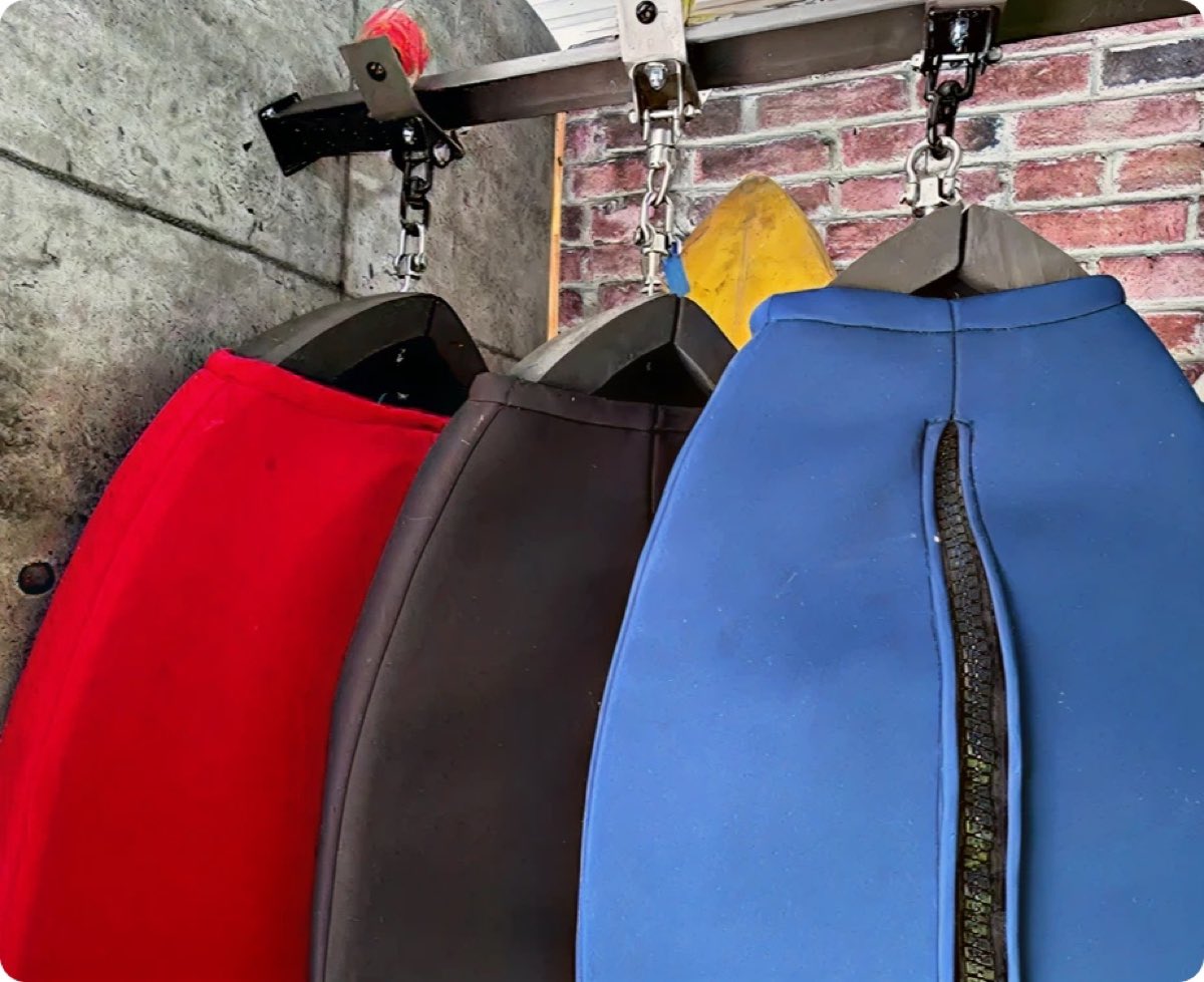 Radd Raxx surfboard storage system mounted on a wall
